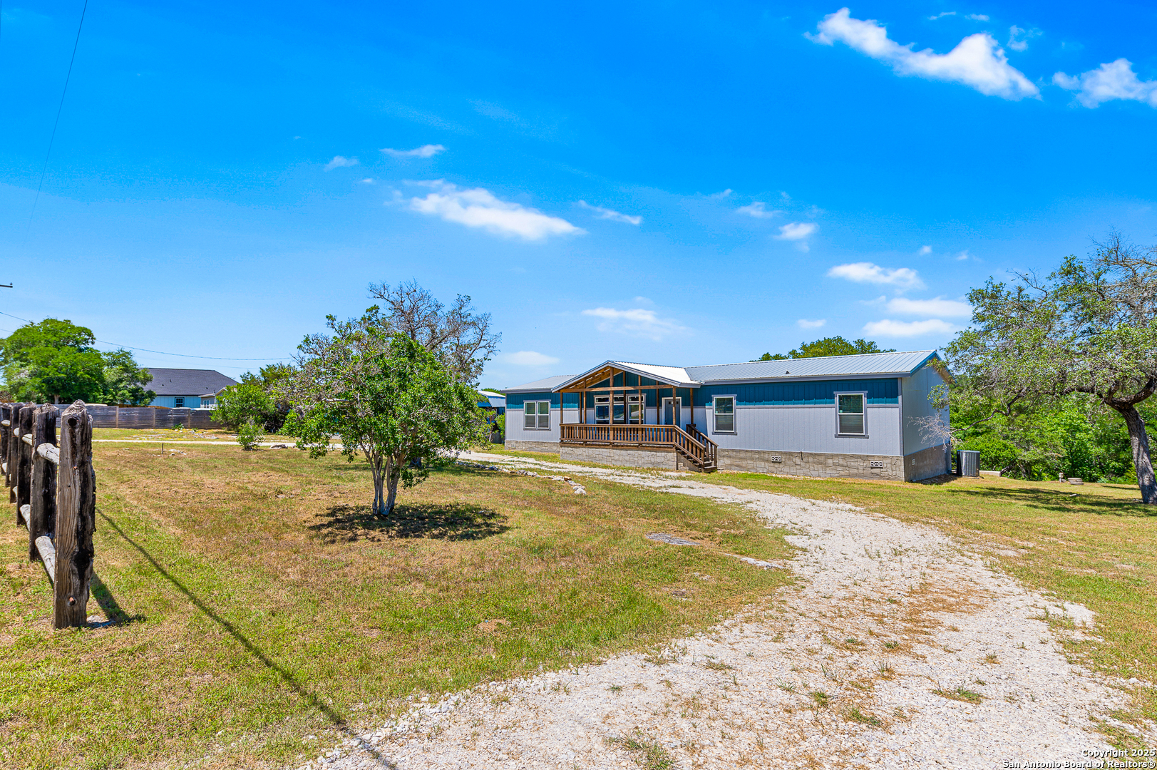 9130 Rebecca Creek Road Spring Branch, TX 78070 - Photo 4 of 77 a view of a house with a yard and sitting area