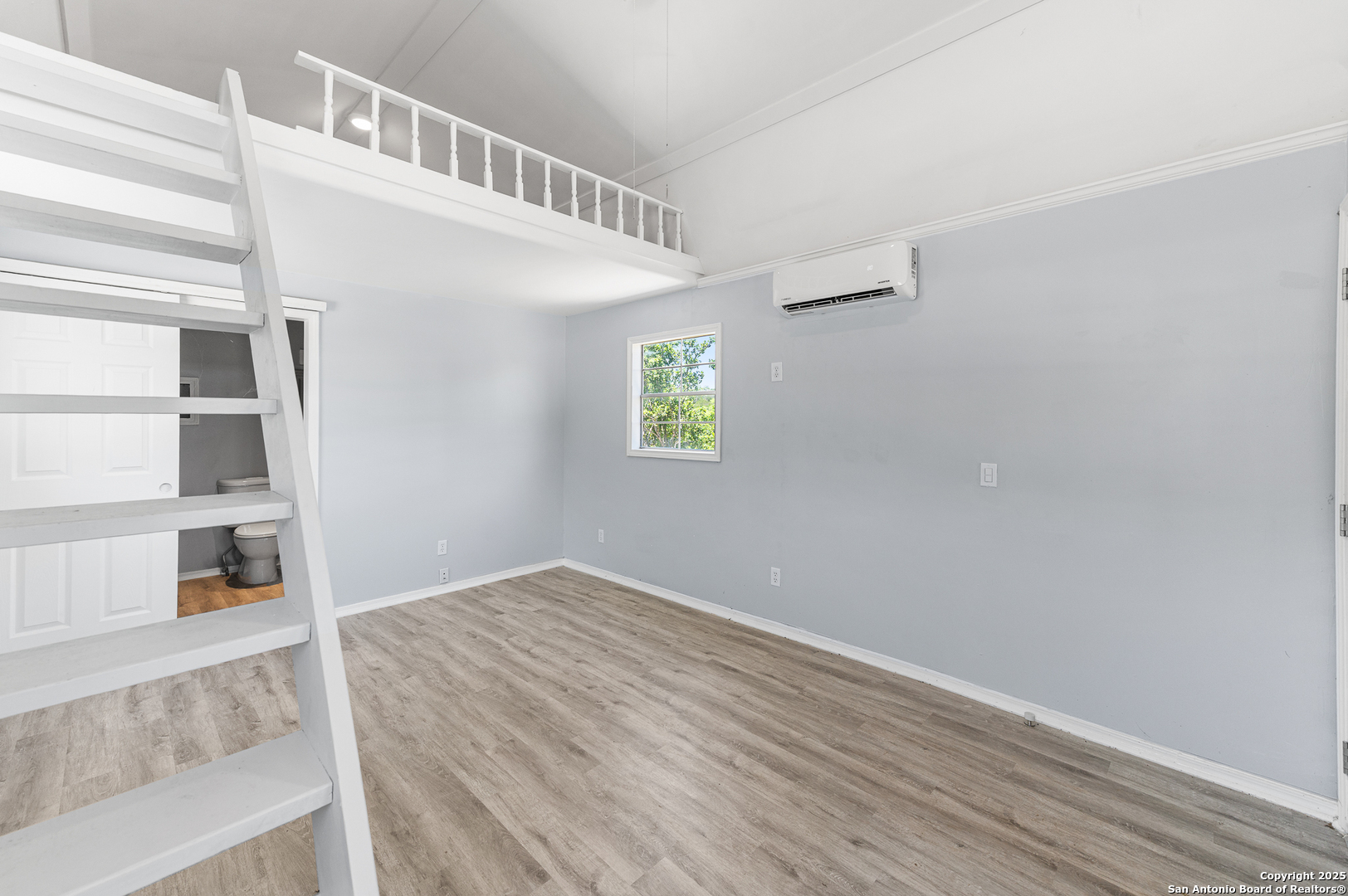 9130 Rebecca Creek Road Spring Branch, TX 78070 - Photo 44 of 77 a view of an empty room with closet and wooden floor