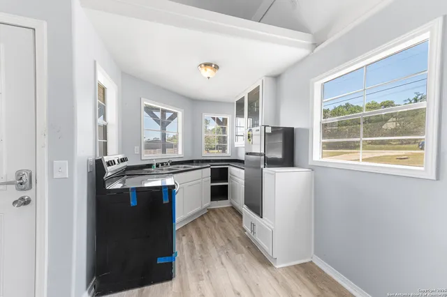 an aerial view of residential houses with outdoor space and ocean view