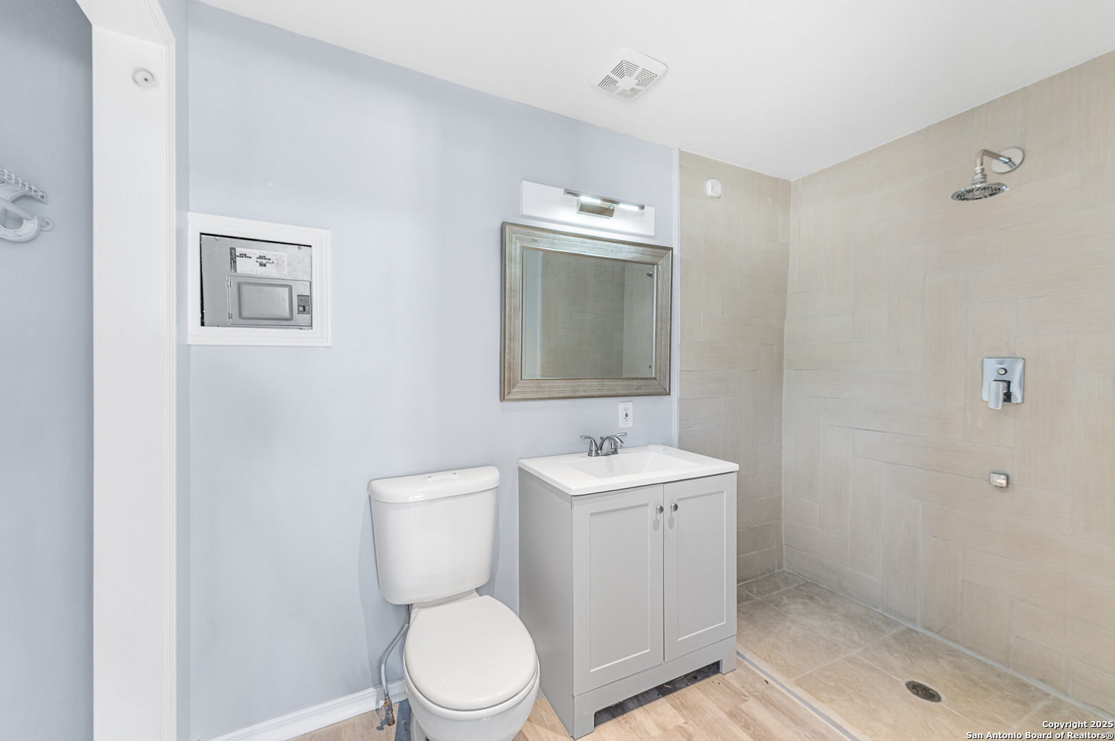 9130 Rebecca Creek Road Spring Branch, TX 78070 - Photo 47 of 77 a bathroom with a toilet a sink a mirror and vanity