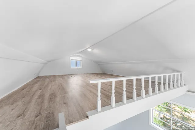 an aerial view of residential houses with outdoor space and trees