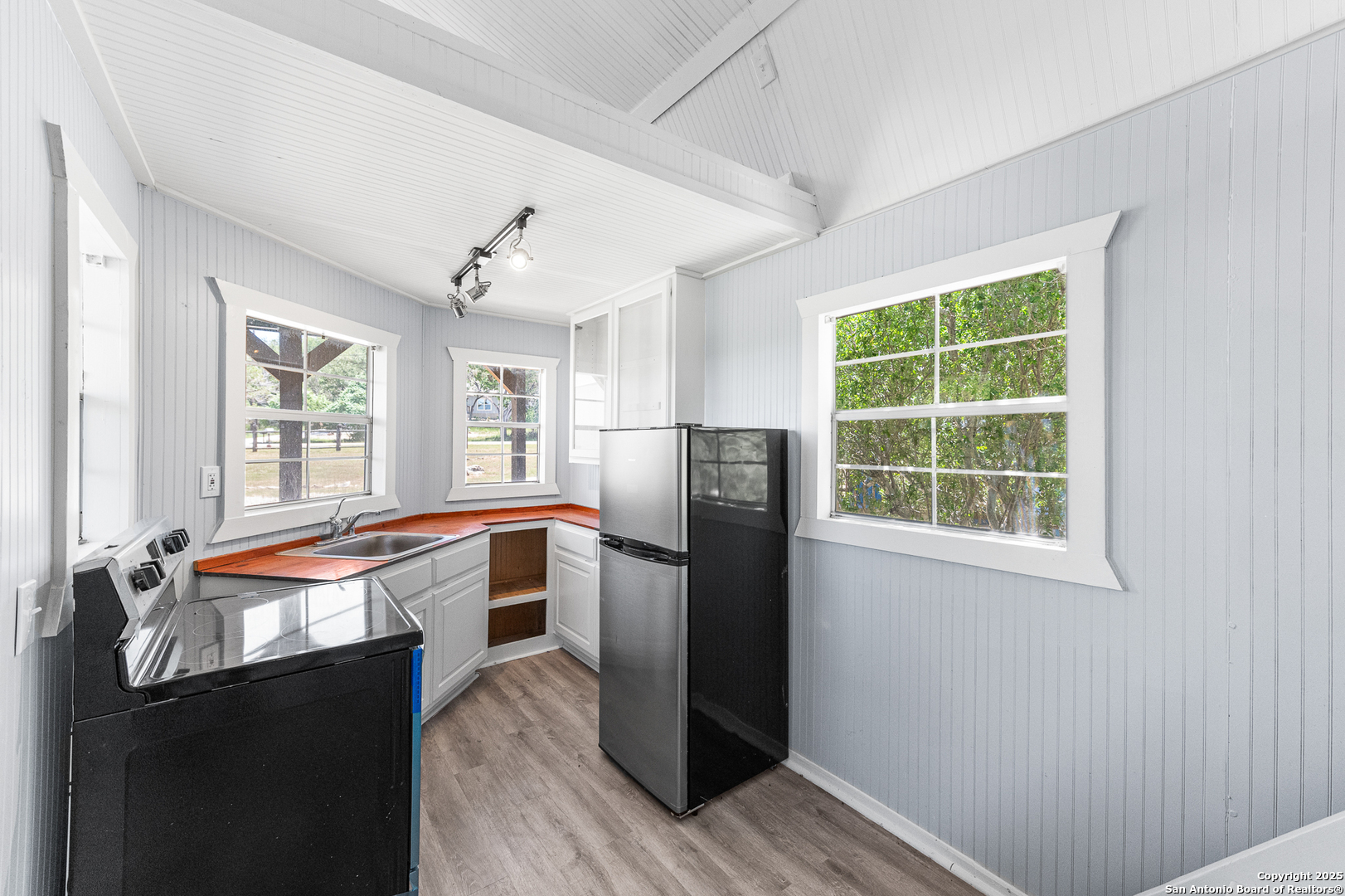 9130 Rebecca Creek Road Spring Branch, TX 78070 - Photo 51 of 77 a kitchen with stainless steel appliances granite countertop a refrigerator and a sink
