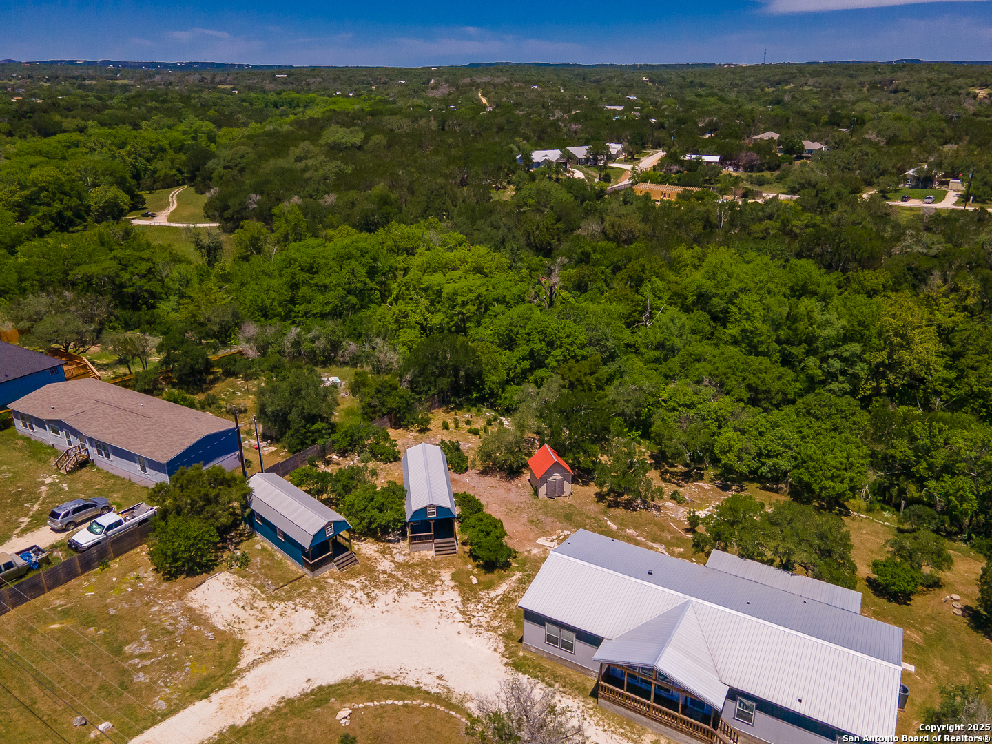 9130 Rebecca Creek Road Spring Branch, TX 78070 - Photo 62 of 77 an aerial view of a houses with a yard