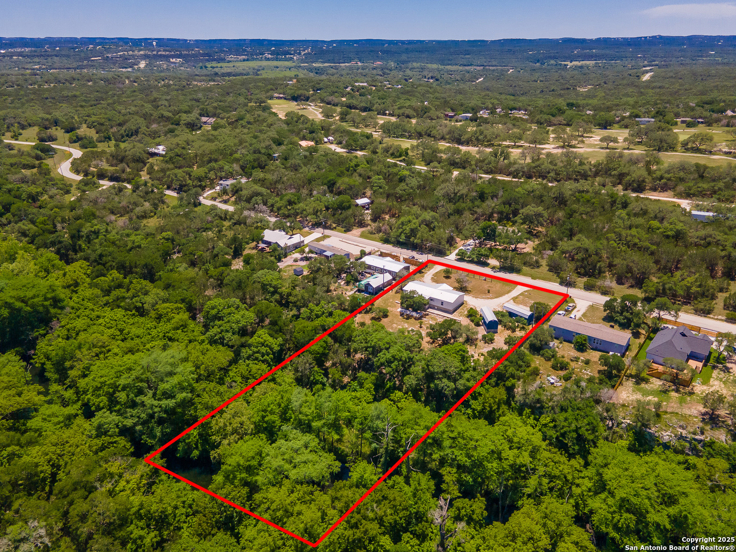 9130 Rebecca Creek Road Spring Branch, TX 78070 - Photo 69 of 77 an aerial view of residential houses with outdoor space and trees