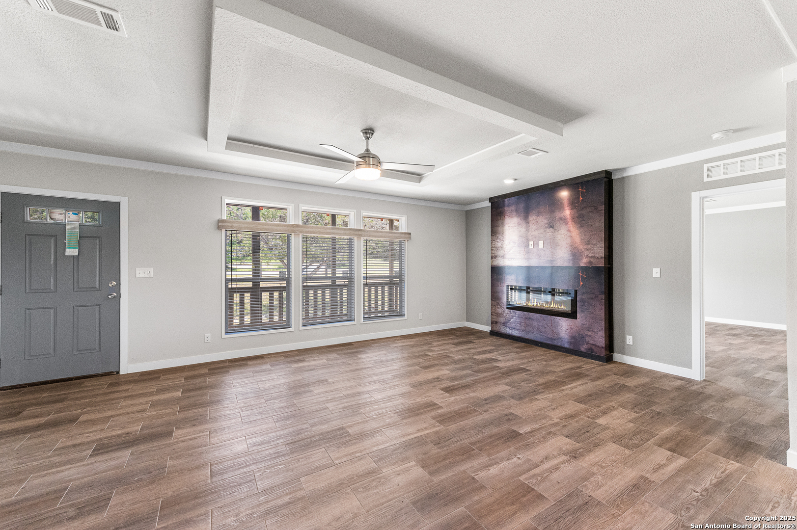 9130 Rebecca Creek Road Spring Branch, TX 78070 - Photo 8 of 77 a view of an empty room with a window and wooden floor