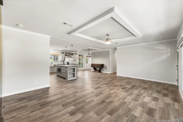 a kitchen with stainless steel appliances granite countertop a sink a stove and a wooden floors
