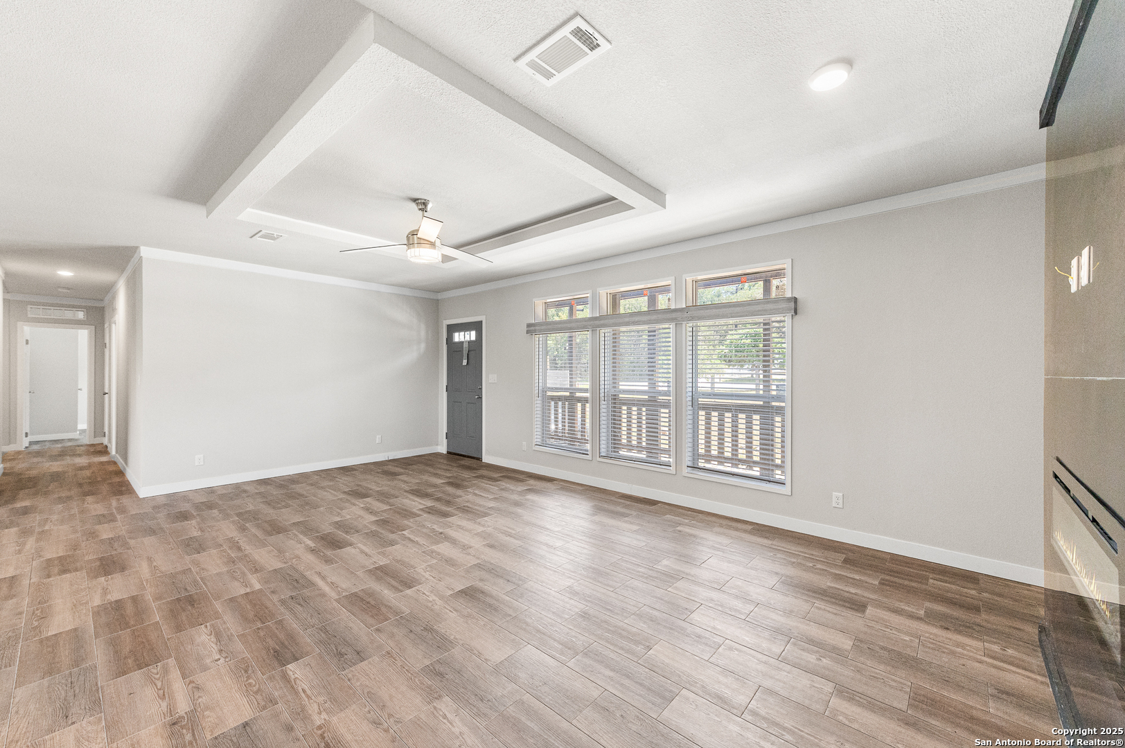 9130 Rebecca Creek Road Spring Branch, TX 78070 - Photo 10 of 77 a view of an empty room with wooden floor and a window