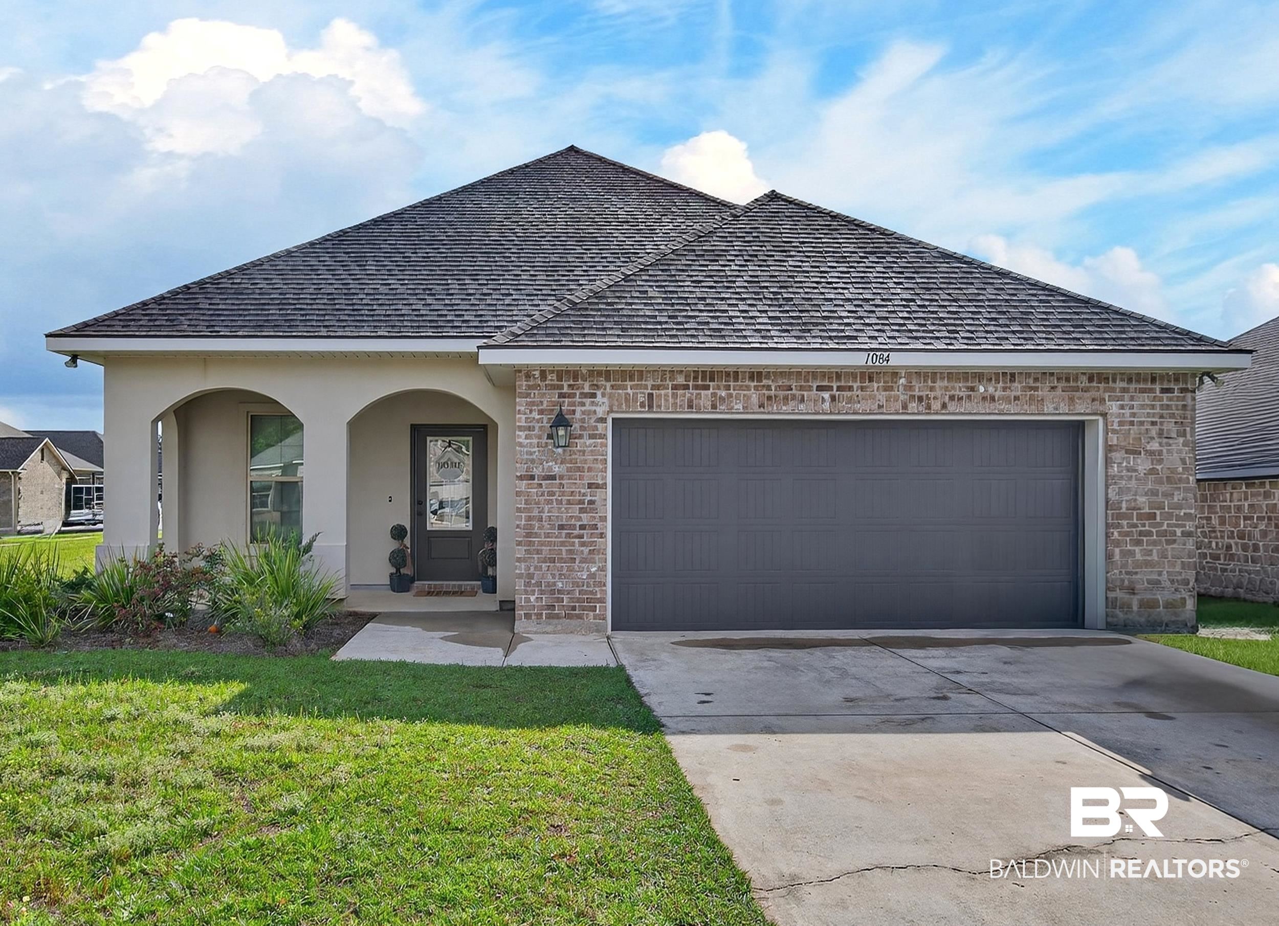 1084 Stella Road Foley, AL 36535 - Photo 1 of 31 View of front facade featuring brick siding, driveway, an attached garage, and roof with shingles