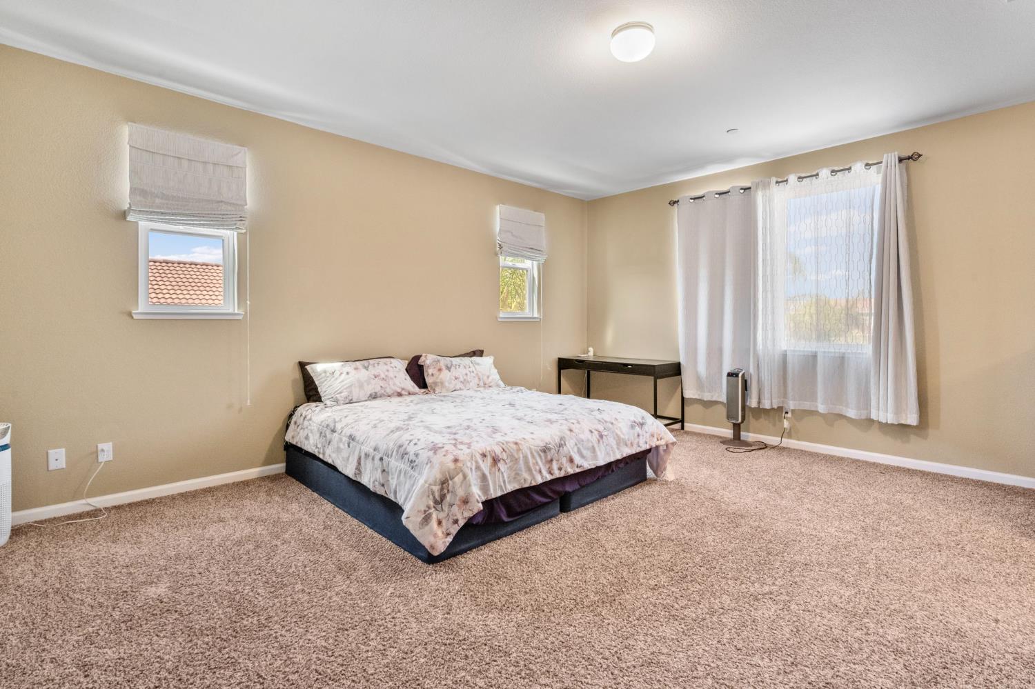 2317 Mathar Drive Manteca, CA 95337 - Photo 30 of 48 a spacious bedroom with a bed and a window