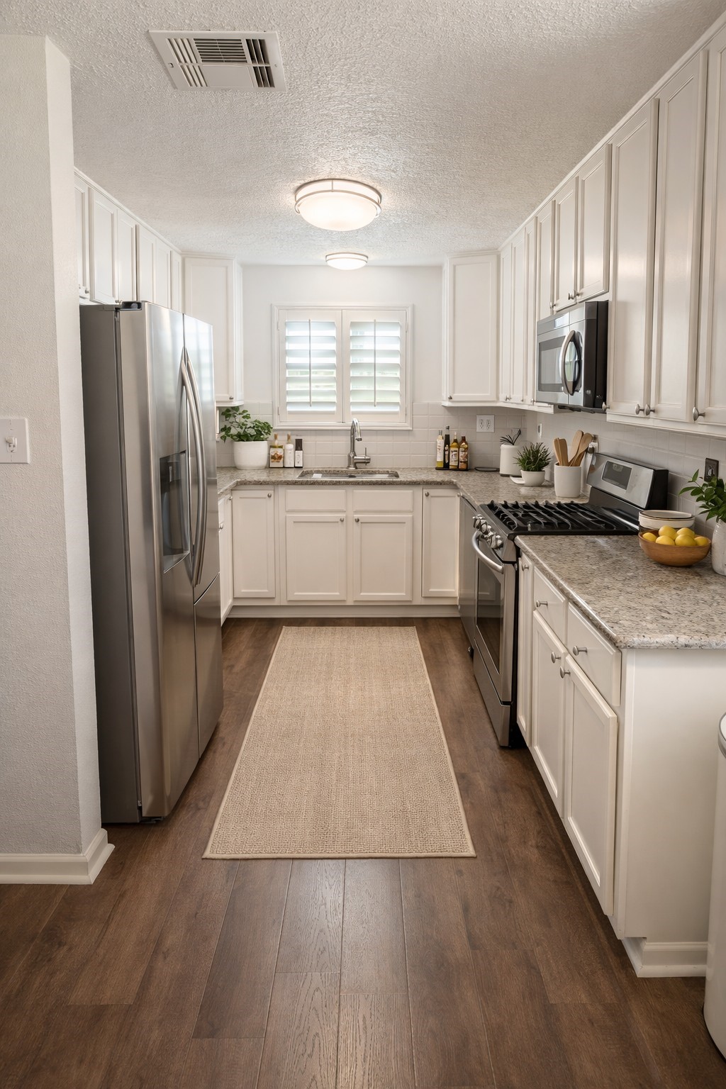 4415 Seminole Street Pasadena, TX 77504 - Photo 6 of 13 a large kitchen with stainless steel appliances granite countertop a stove a sink dishwasher a refrigerator and white cabinets with wooden floor