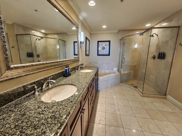 a bathroom with a granite countertop sink mirror and shower