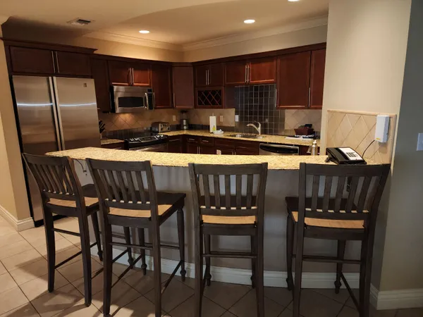 a view of a dining room with furniture and a chandelier