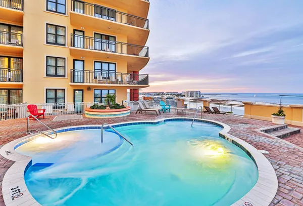 a swimming pool with outdoor seating and city view