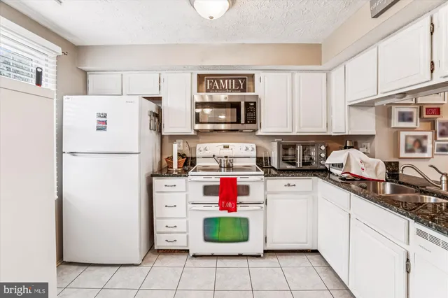 a kitchen with a refrigerator a stove top oven a sink and dishwasher