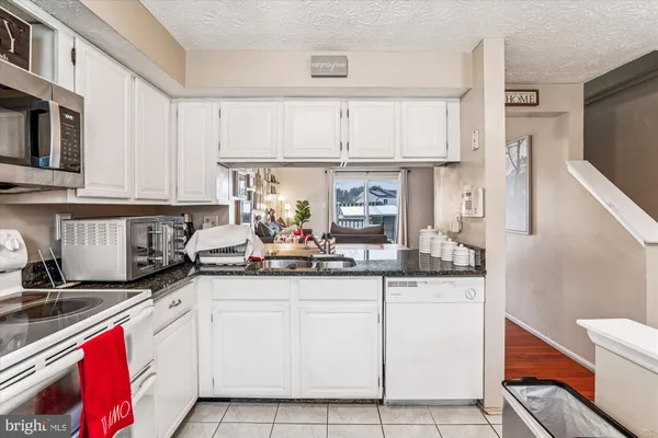 a kitchen with stainless steel appliances granite countertop a sink and cabinets
