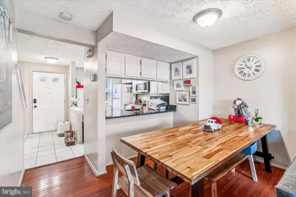a dining room with furniture and a kitchen view