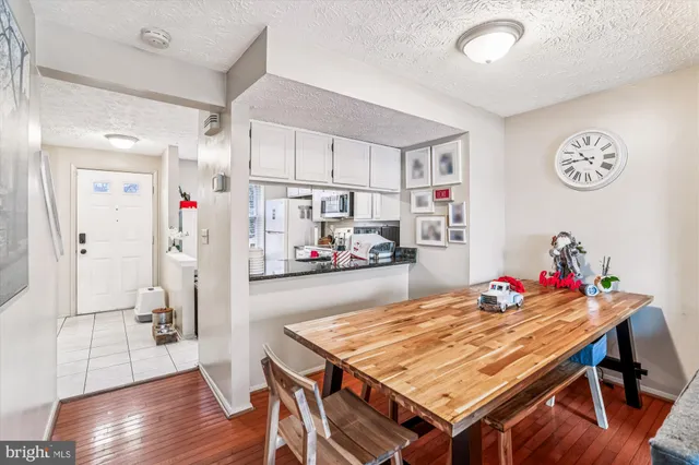 a dining room with furniture and a kitchen view