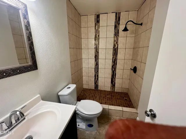 a bathroom with a toilet a sink and shower