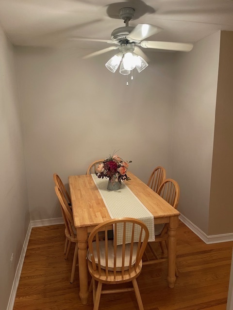 158 East Bailey Road, Unit F Naperville, IL 60565 - Photo 6 of 11 a view of a dining room with furniture and wooden floor