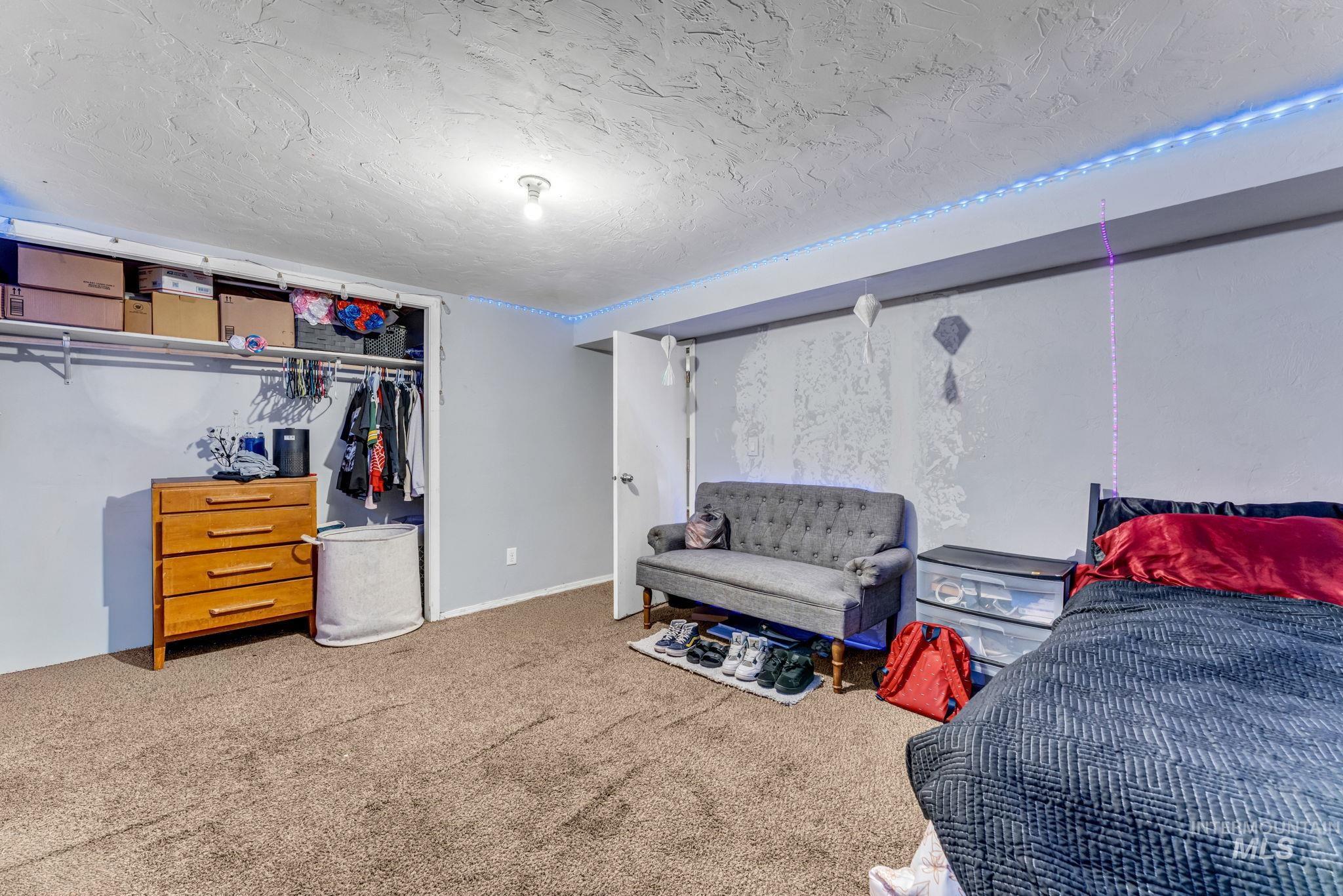 820 Meadows Drive Twin Falls, ID 83301 - Photo 30 of 38 Carpeted lower level featuring a neutral two-tone wall treatment, overhead lighting, multiple doorways, and exposed utility ductwork
