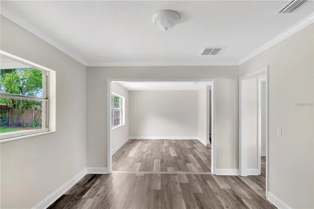 wooden floor in an empty room with a window