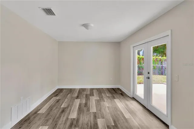 wooden floor in an empty room with a window