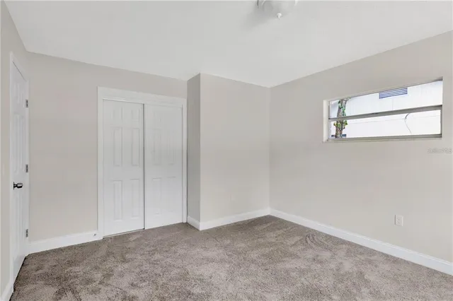 a view of a backyard with a garden and entertaining space