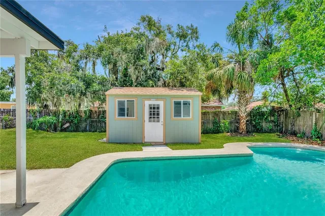a view of a house with a yard and sitting area
