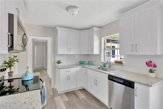 a kitchen with a sink cabinets and window