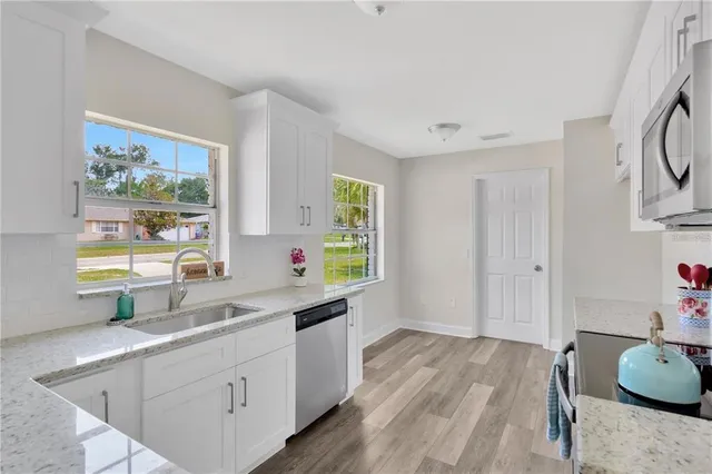 a kitchen that has a sink and a stove in it