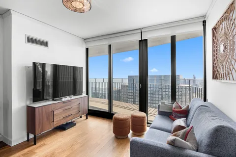 a living room with furniture and a wooden floor