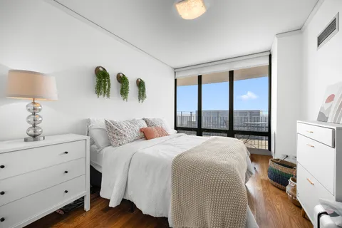 a bedroom with a bed and a window