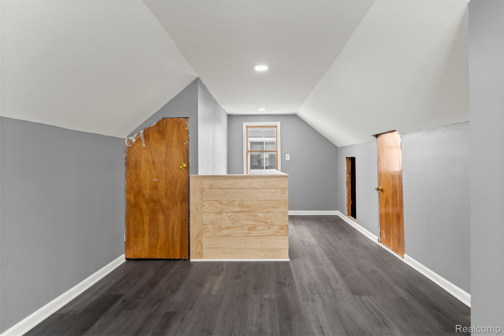 14716 Eureka Road Southgate, MI 48195 - Photo 29 of 42 Additional living space featuring dark wood-style flooring and vaulted ceiling