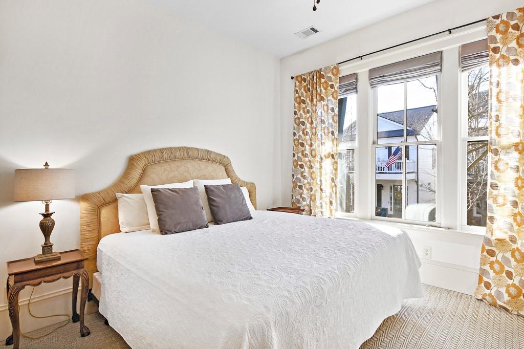 402 Prosper Circle, Unit 102 Marietta, GA 30060 - Photo 11 of 72 a large bed sitting in a bedroom next to a window