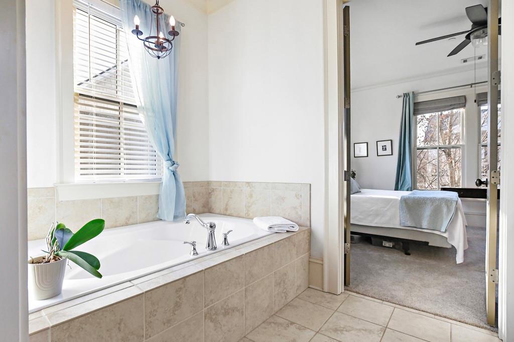 402 Prosper Circle, Unit 102 Marietta, GA 30060 - Photo 24 of 72 a bathroom with a tub and potted plant