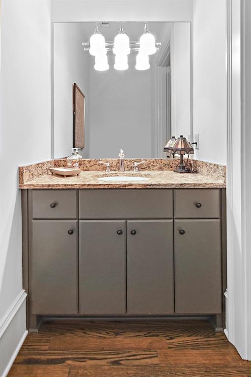 402 Prosper Circle, Unit 102 Marietta, GA 30060 - Photo 10 of 72 a bathroom with a granite countertop sink and a mirror
