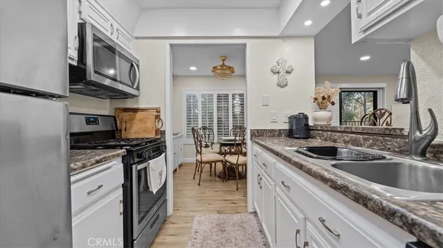 a spacious bedroom with a bed and a chandelier