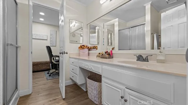 a spacious bathroom with a double vanity sink a mirror and shower