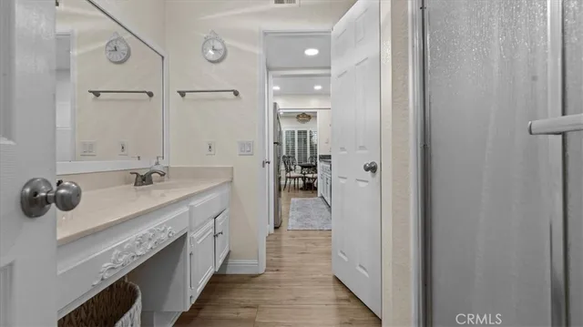 a view of a workspace with furniture and wooden floor