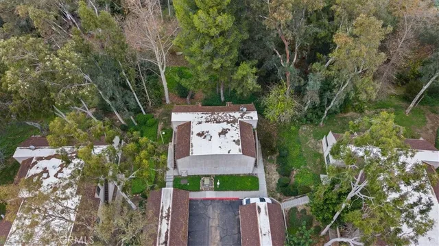 an aerial view of a house with a yard and outdoor seating