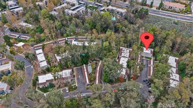 an aerial view of a houses with yard and swimming pool