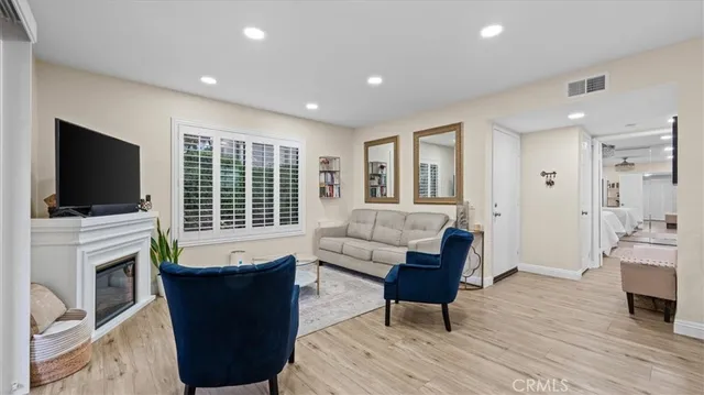 a dining room with furniture and wooden floor