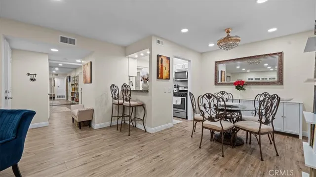 a dining room with furniture and wooden floor
