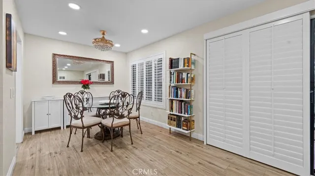 a view of a dining room with furniture and a book shelf
