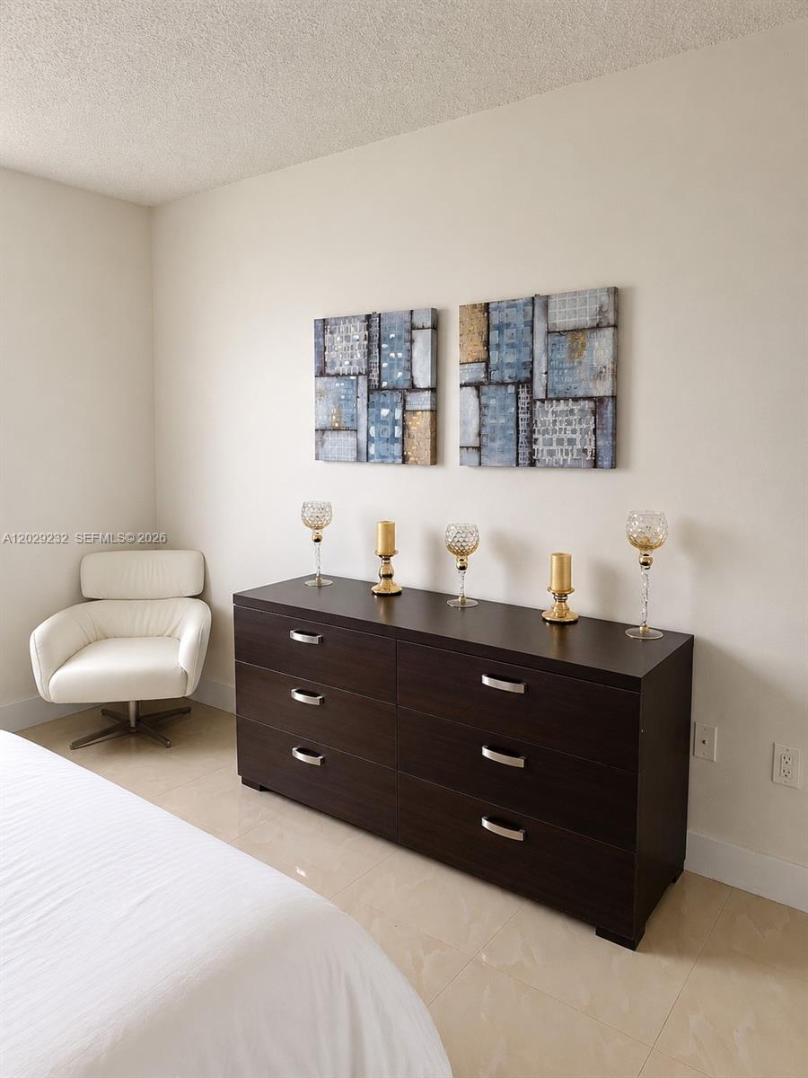 17100 North Bay Road, Unit 1605 Sunny Isles Beach, FL 33160 - Photo 15 of 52 a room with a bed and a night stand