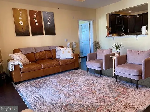 a living room with furniture and a painting