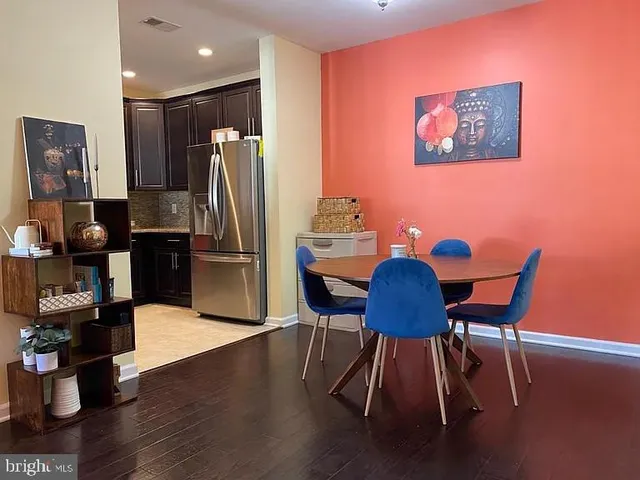 a dining room with furniture and wooden floor