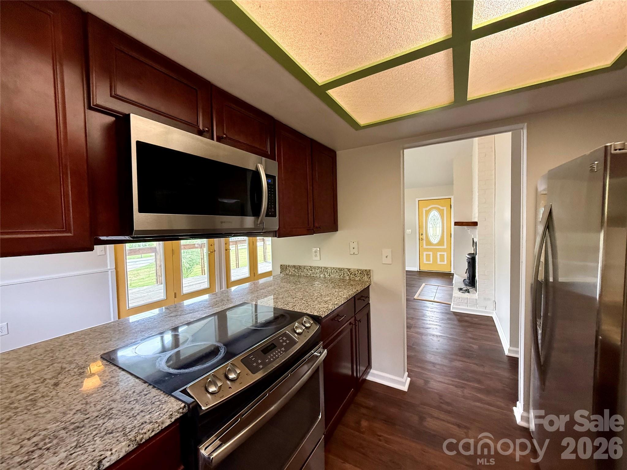 18 Briar Fork Way, Unit 4 Fletcher, NC 28732 - Photo 11 of 36 a kitchen with stainless steel appliances wooden floor and a refrigerator