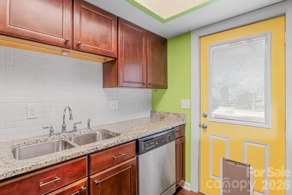 a kitchen with stainless steel appliances granite countertop a sink and a cabinets