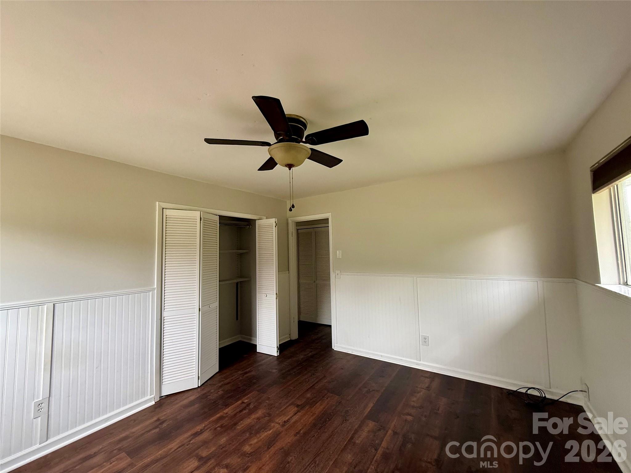 18 Briar Fork Way, Unit 4 Fletcher, NC 28732 - Photo 13 of 36 a view of a livingroom with a ceiling fan and wooden floor